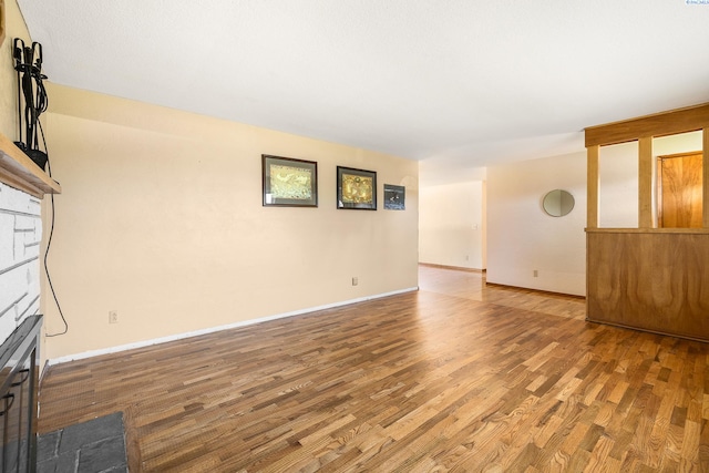2120 Austin St, Richland, WA 99354 - unfurnished living room featuring wood finished floors, a fireplace, and baseboards