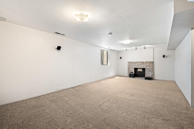 2120 Austin St, Richland, WA 99354 - unfurnished living room with carpet, a fireplace, and rail lighting