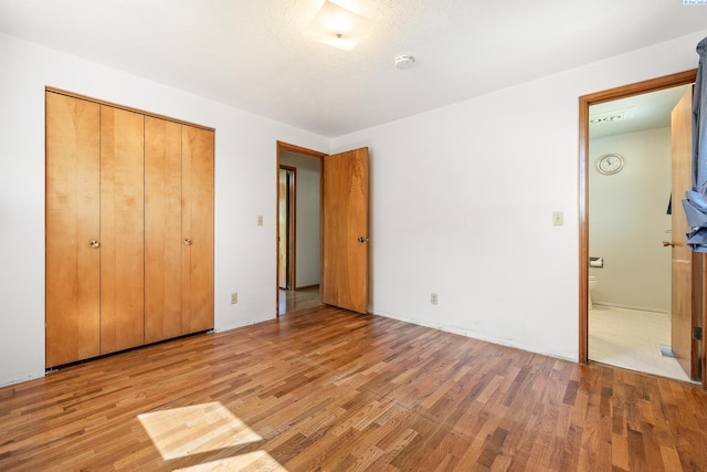 2120 Austin St, Richland, WA 99354 - unfurnished bedroom with wood finished floors and a closet