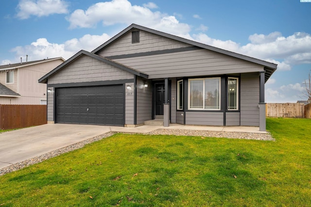 view of front of property featuring a garage and a front yard