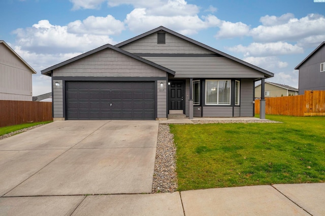 view of front of house featuring a garage and a front lawn