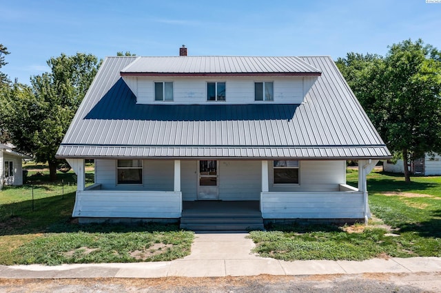212 C St, Endicott, WA 99125 - view of front of property featuring covered porch, a metal roof, and a chimney
