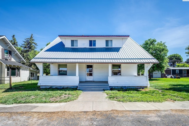212 C St, Endicott, WA 99125 - view of front facade with a porch, a metal roof, and a front yard