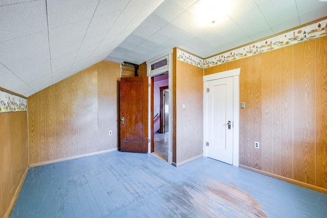 212 C St, Endicott, WA 99125 - unfurnished bedroom featuring wood finished floors, wood walls, and vaulted ceiling