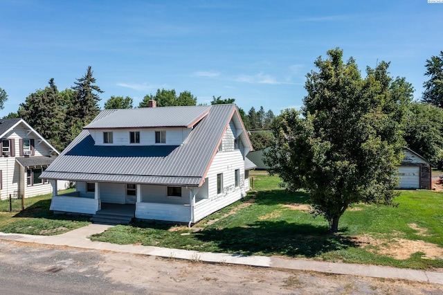212 C St, Endicott, WA 99125 - view of front of house with a porch, a chimney, a front yard, and a metal roof