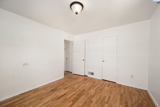3011 W Hood Ave, Kennewick, WA 99336 - unfurnished bedroom with light wood-style flooring, baseboards, and multiple closets