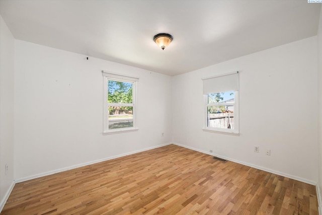 3011 W Hood Ave, Kennewick, WA 99336 - unfurnished room featuring plenty of natural light, light wood-style flooring, and baseboards