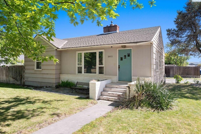 3011 W Hood Ave, Kennewick, WA 99336 - bungalow-style home with a chimney, a shingled roof, and brick siding