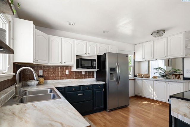 3011 W Hood Ave, Kennewick, WA 99336 - kitchen featuring stainless steel fridge, black microwave, a sink, white cabinets, and light countertops