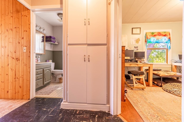 bathroom featuring toilet and wood walls