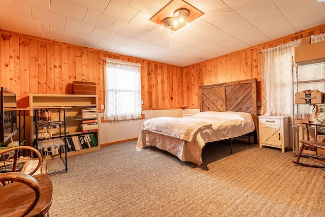 carpeted bedroom with wood walls