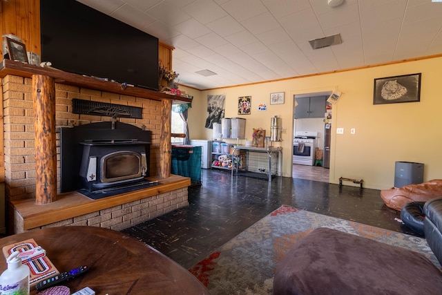 living room featuring ornamental molding and a wood stove