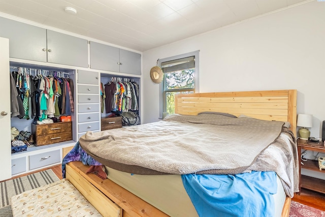 bedroom with crown molding and hardwood / wood-style flooring