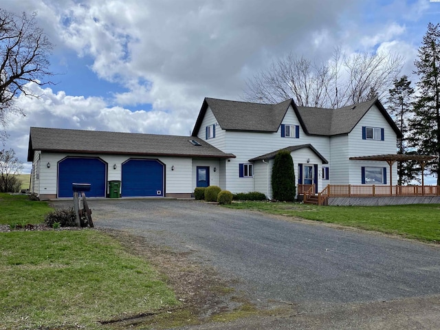 view of front of home featuring a garage, a front yard, and a pergola