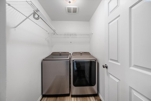 1713 W 39th Ave, Kennewick, WA 99337 - washroom with washer and clothes dryer and light wood-type flooring