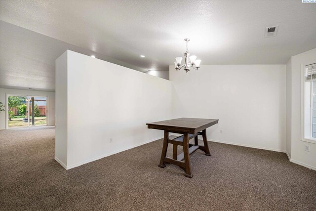 1713 W 39th Ave, Kennewick, WA 99337 - unfurnished dining area featuring carpet floors, a chandelier, and a textured ceiling