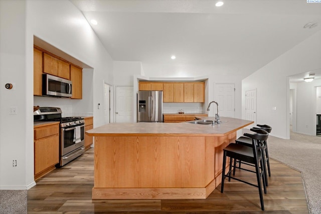 1713 W 39th Ave, Kennewick, WA 99337 - kitchen featuring appliances with stainless steel finishes, a large island, a breakfast bar, light countertops, and recessed lighting