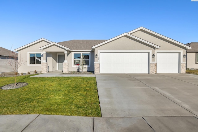 view of front of house featuring a front yard and a garage