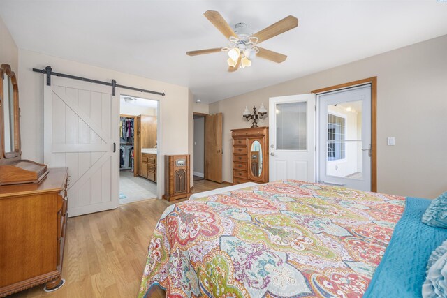 2532 W 32nd Ave, Kennewick, WA 99337 - bedroom featuring light wood-type flooring, a barn door, a ceiling fan, and ensuite bathroom