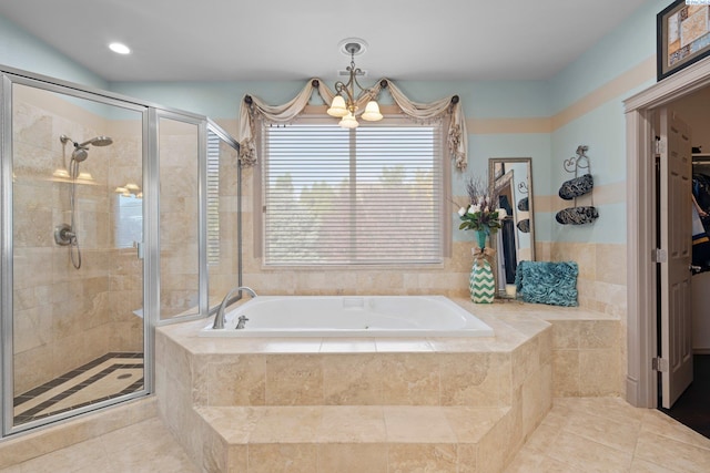 bathroom with tile patterned flooring, plus walk in shower, and a notable chandelier