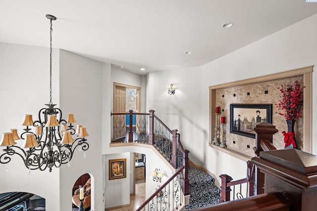 staircase featuring a chandelier