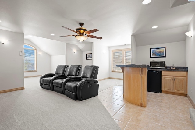 living room with lofted ceiling, a healthy amount of sunlight, light tile patterned floors, and ceiling fan