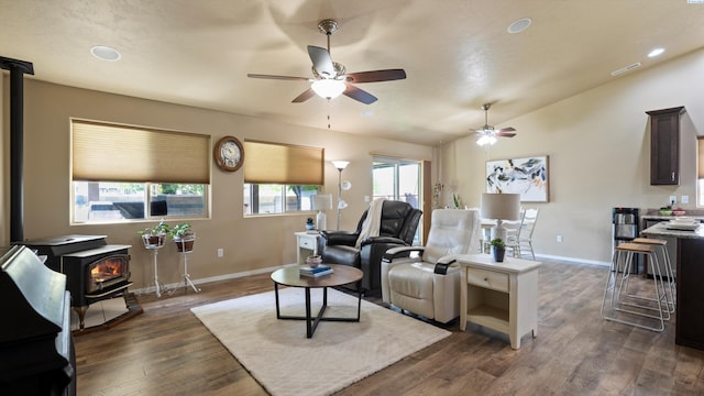 4902 NW Commons Dr, Pasco, WA 99301 - living room featuring a wood stove, a ceiling fan, baseboards, dark wood finished floors, and recessed lighting