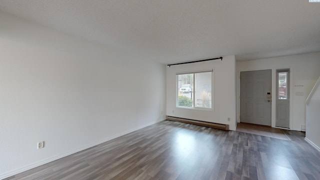 entrance foyer with hardwood / wood-style floors and baseboard heating