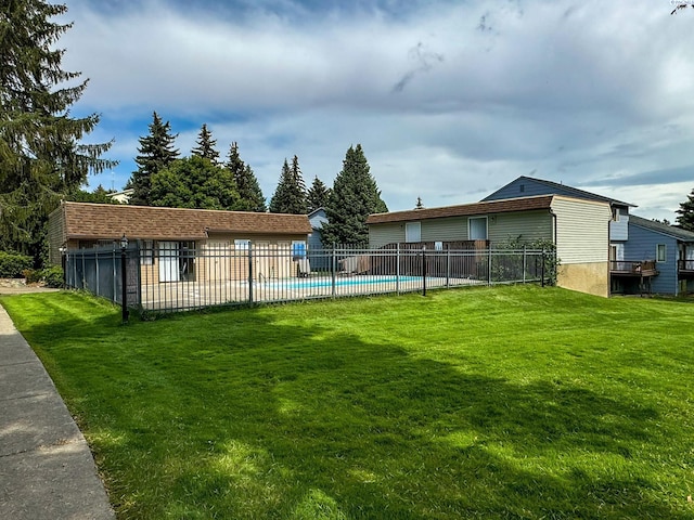 view of yard with a fenced in pool