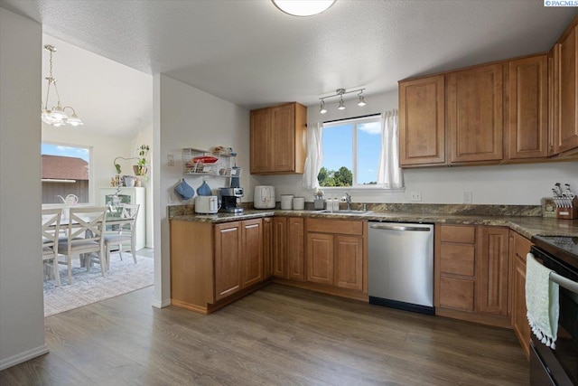 2132 Cascade Ave, Richland, WA 99354 - kitchen featuring stainless steel appliances, brown cabinetry, a chandelier, and dark wood-type flooring