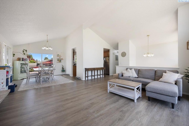 2132 Cascade Ave, Richland, WA 99354 - living room featuring a chandelier, wood finished floors, a textured ceiling, and high vaulted ceiling