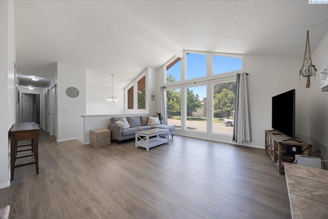 2132 Cascade Ave, Richland, WA 99354 - living area featuring a chandelier, a textured ceiling, wood finished floors, and lofted ceiling