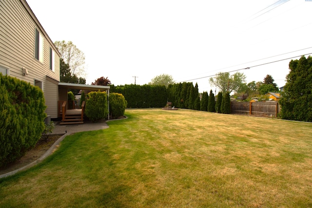 view of yard with fence and a wooden deck