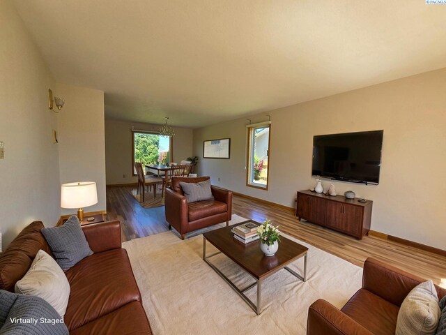 5307 W Irving St, Pasco, WA 99301 - living area with wood finished floors, a chandelier, and baseboards