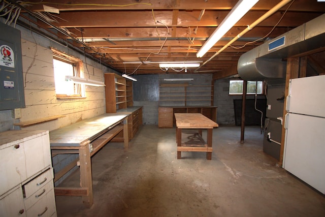 5307 W Irving St, Pasco, WA 99301 - basement with freestanding refrigerator, a workshop area, and electric panel