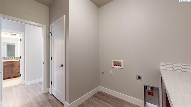 4801 White Dr, Richland, WA 99352 - clothes washing area featuring hookup for a washing machine, hookup for an electric dryer, and light hardwood / wood-style flooring