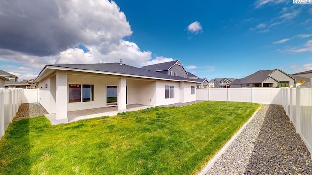 4801 White Dr, Richland, WA 99352 - rear view of house with a lawn and a patio