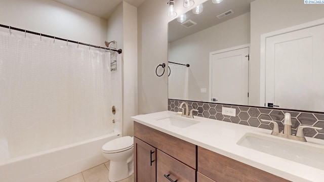 4801 White Dr, Richland, WA 99352 - full bathroom featuring shower / bath combo, tile patterned flooring, vanity, decorative backsplash, and toilet