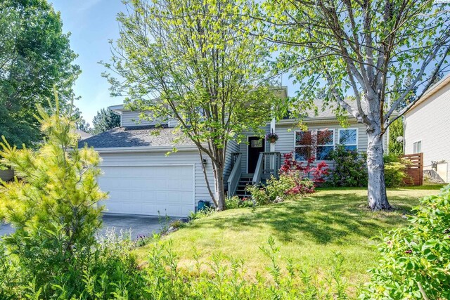 495 NW Robert St, Pullman, WA 99163 - obstructed view of property featuring a front yard and asphalt driveway