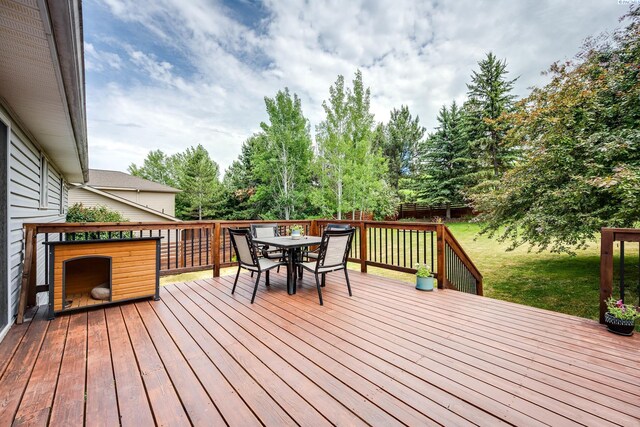 495 NW Robert St, Pullman, WA 99163 - wooden terrace with outdoor dining area, a fenced backyard, and view of scattered trees