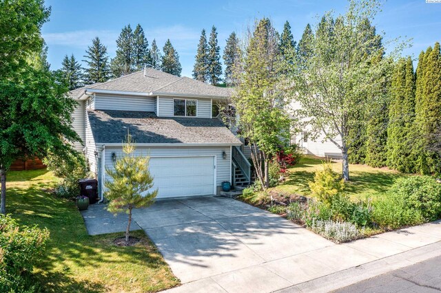 495 NW Robert St, Pullman, WA 99163 - view of front of house featuring driveway, stairs, a front lawn, roof with shingles, and an attached garage