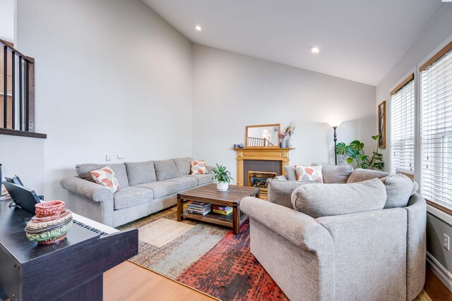 495 NW Robert St, Pullman, WA 99163 - living area featuring lofted ceiling, wood finished floors, plenty of natural light, a glass covered fireplace, and recessed lighting