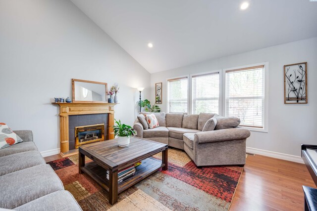 495 NW Robert St, Pullman, WA 99163 - living room featuring healthy amount of natural light, wood finished floors, recessed lighting, a tile fireplace, and high vaulted ceiling