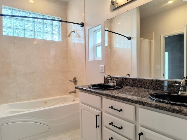 full bath featuring plenty of natural light, shower / bath combo, and a sink