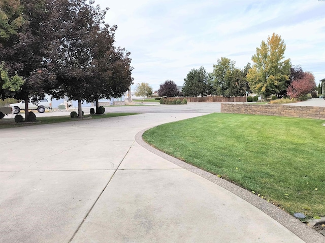 view of road featuring concrete driveway