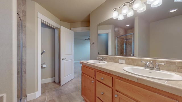 bathroom with vanity, backsplash, and walk in shower