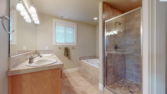 bathroom featuring vanity, tile patterned flooring, tasteful backsplash, and independent shower and bath