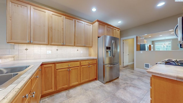 kitchen with stainless steel appliances, sink, and decorative backsplash