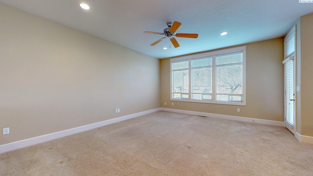 carpeted spare room with ceiling fan