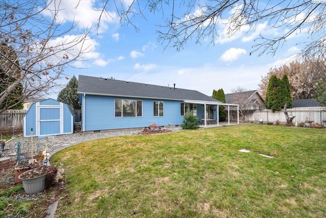 rear view of property with an outbuilding, a patio, a lawn, a shed, and a fenced backyard